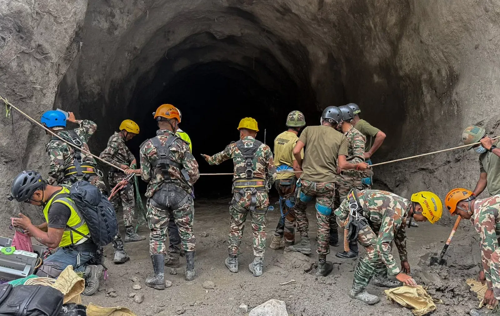 Military engineers conduct a rescue operation inside an underground access tunnel at the Upper Trishuli project following the glacier collapse.