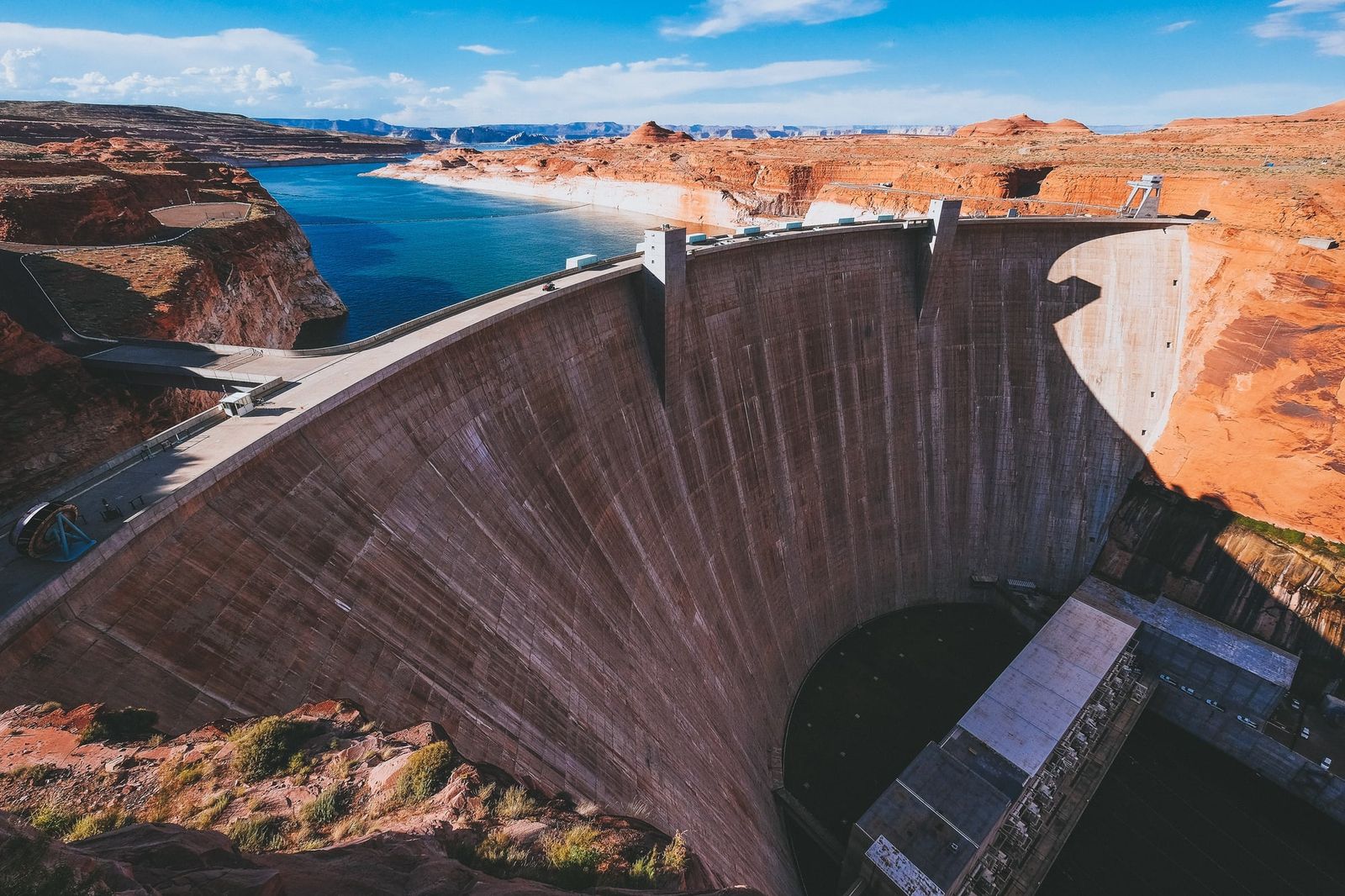 Glen Canyon Dam regulates Lake Powell, one of the two primary reservoirs whose record-low levels prompted federal water managers to mandate demand reductions.