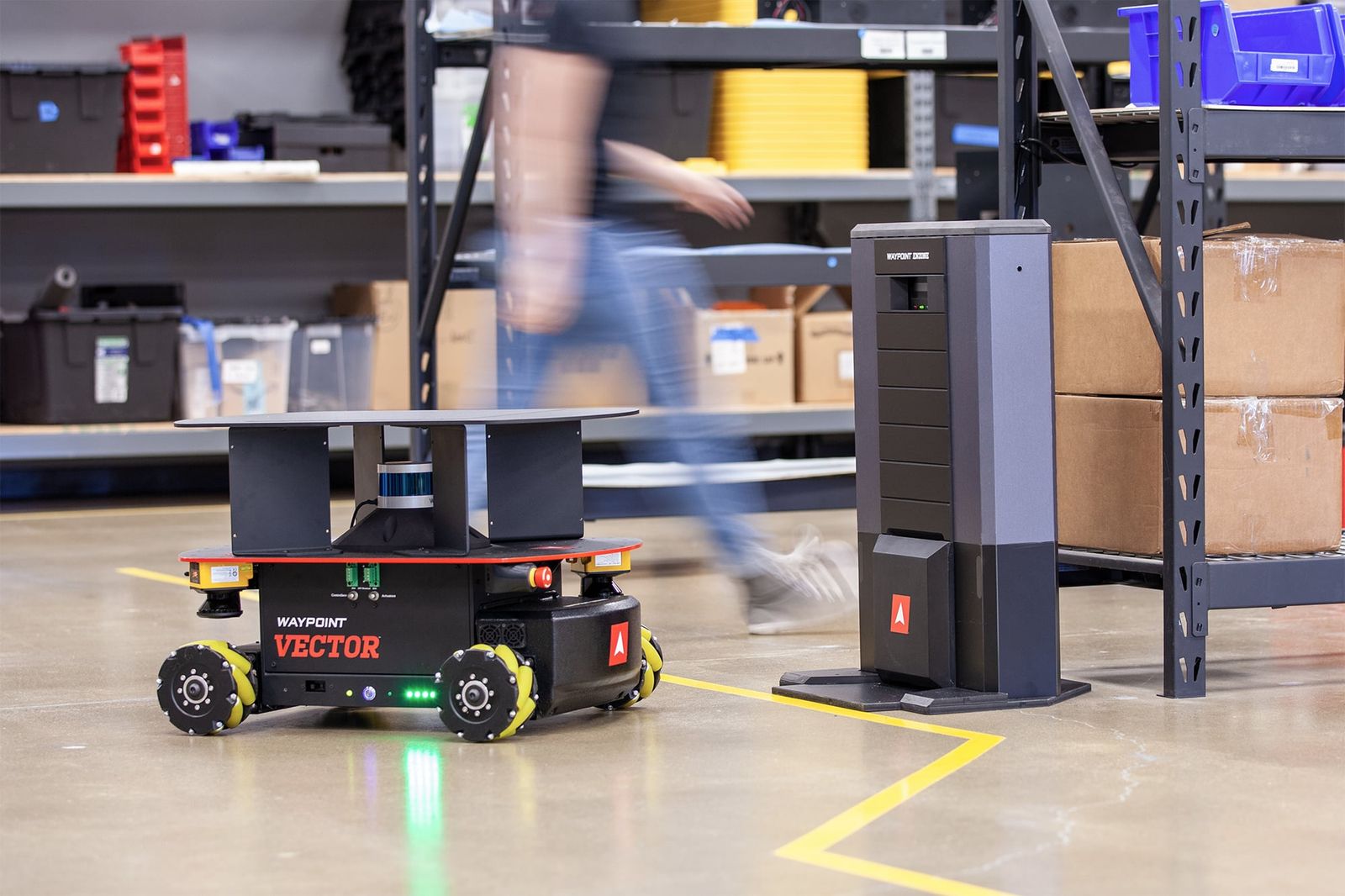 An autonomous mobile robot on a factory floor exemplifies the physical automation that public policy struggles to manage as systems acquire wheels and limbs.